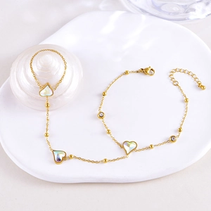 Elegant gold finger bracelet with heart-shaped colorful gemstones and delicate chain link