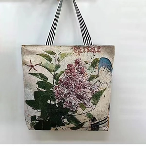 Detailed pattern of vintage floral lilac and butterfly prints on canvas tote bag