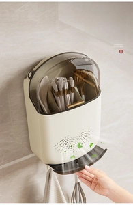 Close-up of wall-mounted kitchen organizer with breathable drain holes and water tray