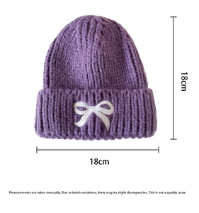Detailed view of dark purple knitted beanie with white bow embroidery and 18cm dimensions