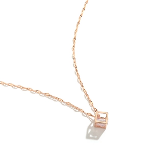 Rose gold geometric cube pendant necklace with clear zircon on a white background