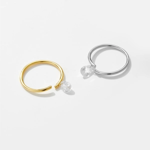 Close-up of gold and silver adjustable rings with teardrop cubic zirconia crystals