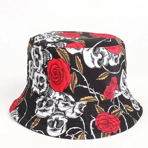 Detail of dark style bucket hat featuring realistic skull and red rose floral prints