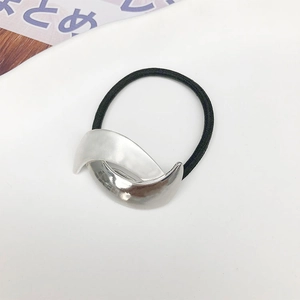 Detailed view of silver crescent metal ponytail holder with black elastic hair tie