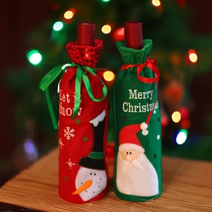 Detail of Christmas wine bottle covers with Snowman and Santa embroidery on fabric