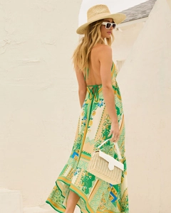 Close-up of bohemian floral maxi dress with backless halter tie design and fluid fabric