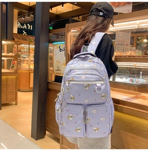 Detail of lavender bear pattern backpack with multiple storage pockets for students