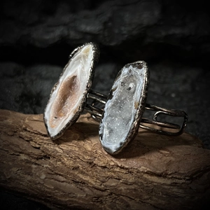 Detailed close-up of natural white and orange geode agate slices on an adjustable ring band