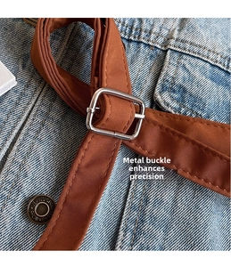 Detailed macro view of high-quality silver metal buckle on brown canvas strap