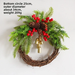 Detail view of farmhouse Christmas wreath with red berries, pinecones and gold bells