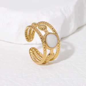 Detailed view of an 18K gold-plated twisted rope ring with shell enamel accents