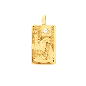 Macro detail of a gold tarot card pendant with embossed knight and sun motif