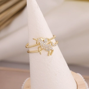 Detail view of gold unicorn ring featuring micro-pave cubic zirconia on a conical stand