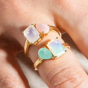 Titanium steel ring with square moonstone and opal in a gold finish on finger