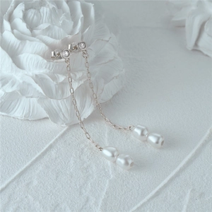 Macro detail of S925 silver long tassel earrings with baroque pearls and zircon