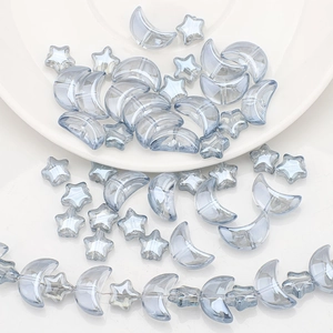 Macro shot of iridescent moon and star shaped beads for DIY jewelry making and crafts