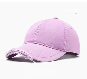 Detail of light purple distressed cotton baseball cap with frayed edges and retro style