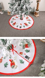 Detail of Christmas tree skirt with festive cartoon elf prints and red ribbon ties