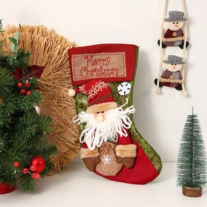 Detail of a large vintage Christmas stocking with 3D Santa Claus and Merry Christmas tag