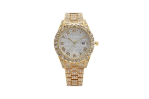 Close-up of golden rhinestone watch with Roman numerals and calendar display