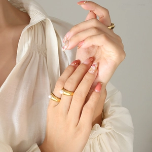 Elegant French gold pearl ring featuring a wide band and minimalist freshwater pearl design