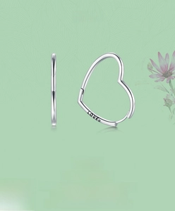 Close-up of S925 sterling silver heart-shaped hoop earrings with LOVE engraving