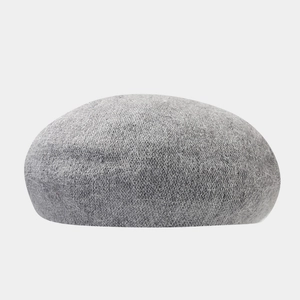 Close-up of the grey angora beret showing soft plush texture and warm knit material