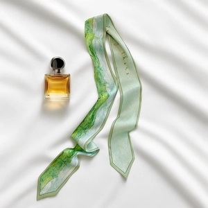 Artistic oil painting style silk scarf with green tones and perfume bottle on white fabric