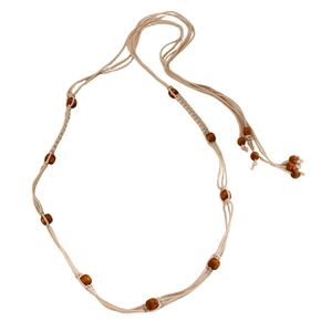 Detail of bohemian waist chain with woven rope, wooden beads, and natural sea shells