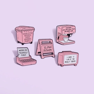 Set of five pink vintage enamel pins featuring typewriter and inspirational slogans