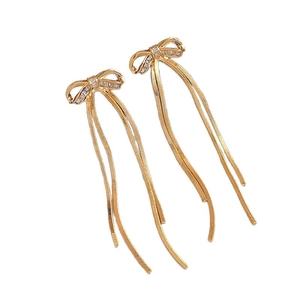 Golden bow pearl earrings with long snake chain tassels and sparkling diamond accents