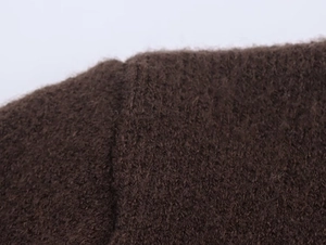 Detail of the high-quality dark brown knitted mohair fabric with soft hairy texture