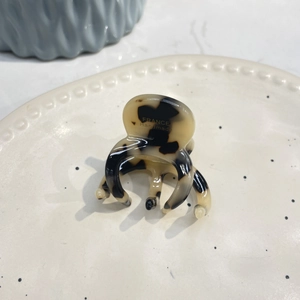 Close-up of tortoise shell pattern hair claw with gold France Handmade logo engraving