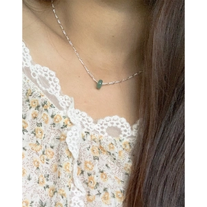 Elegant S925 sterling silver necklace with a round green jade pendant on female model