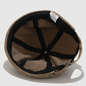 Detail of docker hat showing internal 100% cotton structure and adjustable metal strap buckle
