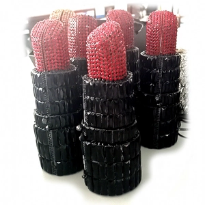 Detail shot of luxury lipstick-shaped clutch bags with red and black rhinestone sparkling