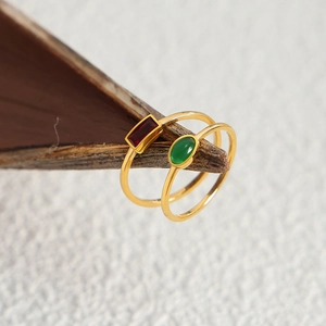 Minimalist gold titanium steel rings set with red rectangle and green oval gemstones