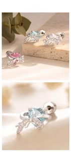 Macro detail of bow heart titanium steel stud earrings with pink and blue zircon stones