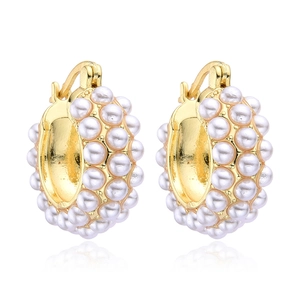 Elegant gold C-shaped hoop earrings featuring inlaid white pearls on white background