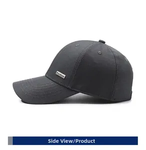 Detail view of dark grey baseball cap with side metal Fashion tag and textured fabric