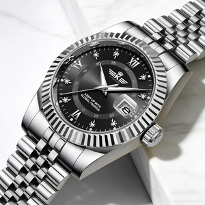 Close-up of black dial men's steel watch with crystal markers and calendar window detail