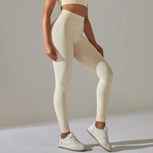 Detail view of seamless high-waisted beige yoga leggings with ribbing and side-profile fit