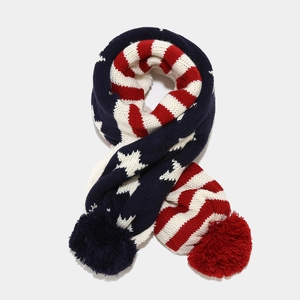 Detail view of the American flag pattern knitted scarf with soft red and blue pompoms