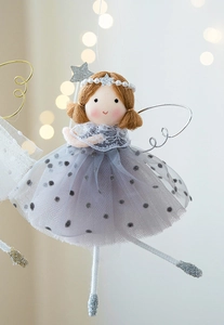 Close-up of fairy doll with silver wings and grey polka dot skirt for holiday decoration