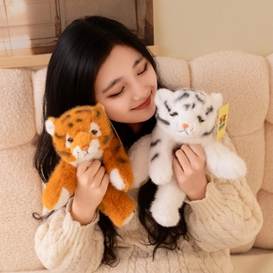 Realistic white and yellow plush tiger doll toys shown in a cozy home setting