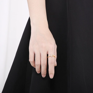 Detail view of gold plated cross ring with micro-set zircon on model's hand