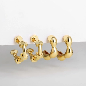 Detailed macro view of 18K gold-plated geometric stud earrings in minimalist style