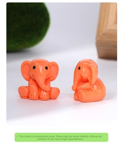 Detailed macro view of two cute orange resin elephant figurines for desk decoration