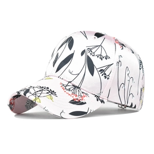 Detail of floral printed baseball cap featuring elegant botanical patterns and curved brim