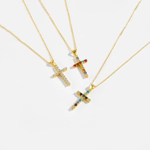 Three gold S925 sterling silver necklaces with colorful zircon cross pendants on white background